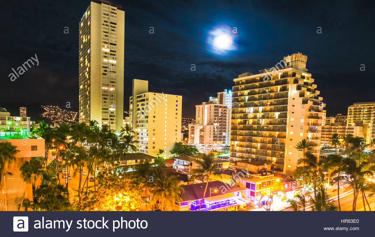 Moonlight aerial view on night traffic of Waikiki city in Oahu