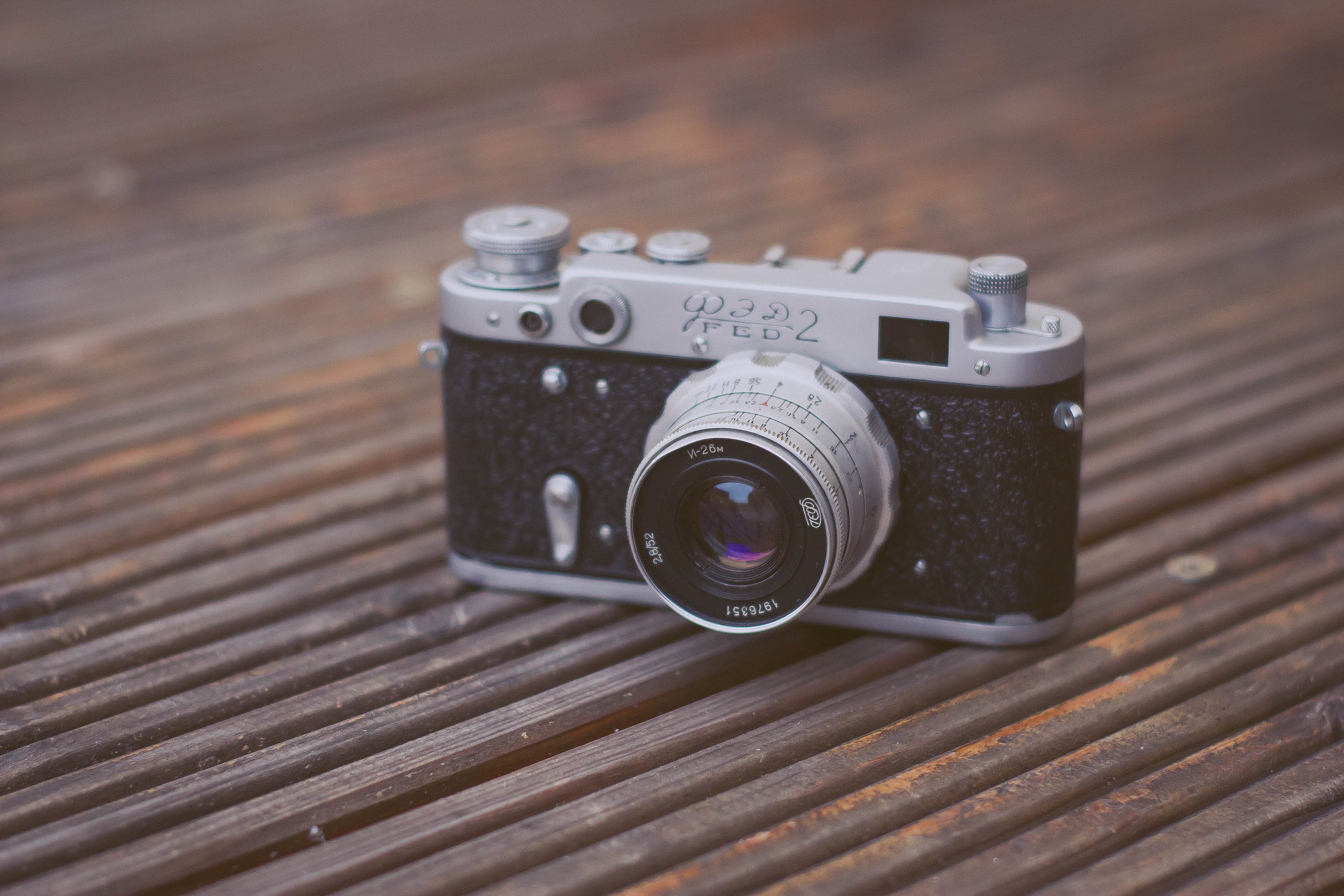 Black And Gray Film Camera On Brown Wooden Surface Stock