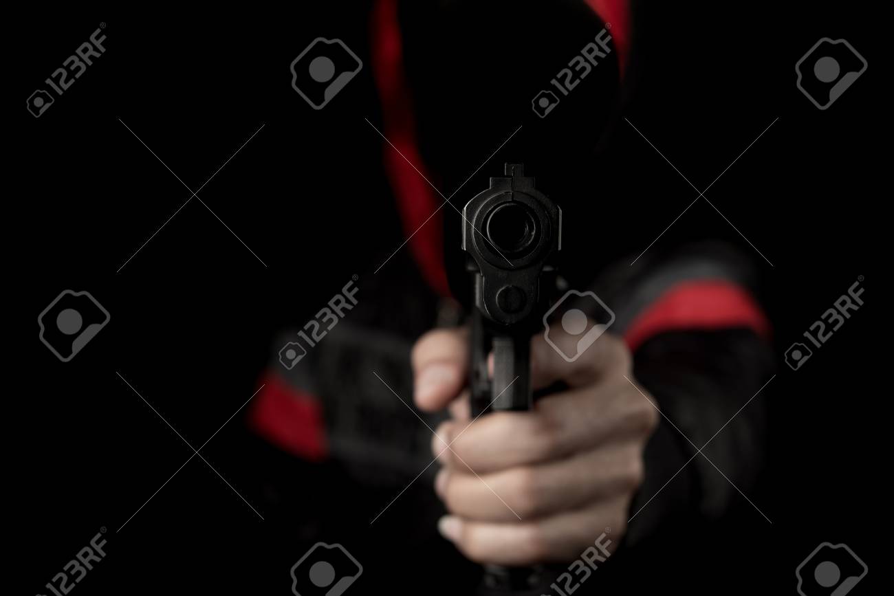 Man Holding And Shoot Gun Thief Or Bandit On Dark Black Background