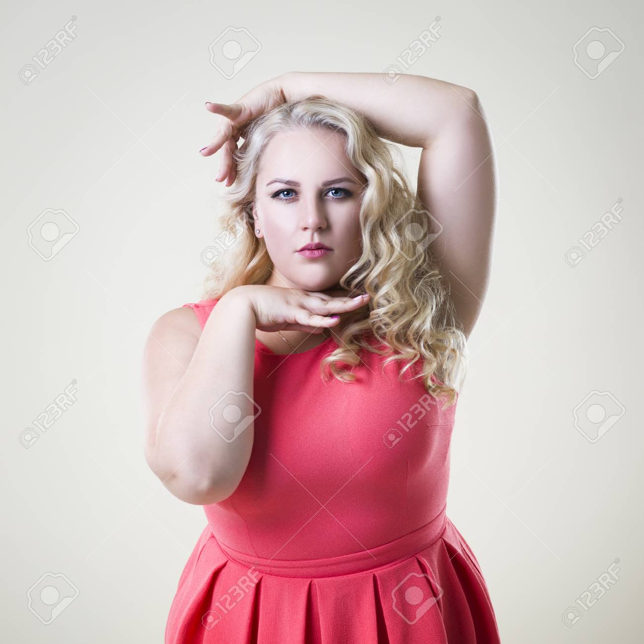 Plus Size Fashion Model Fat Woman On Beige Studio Background