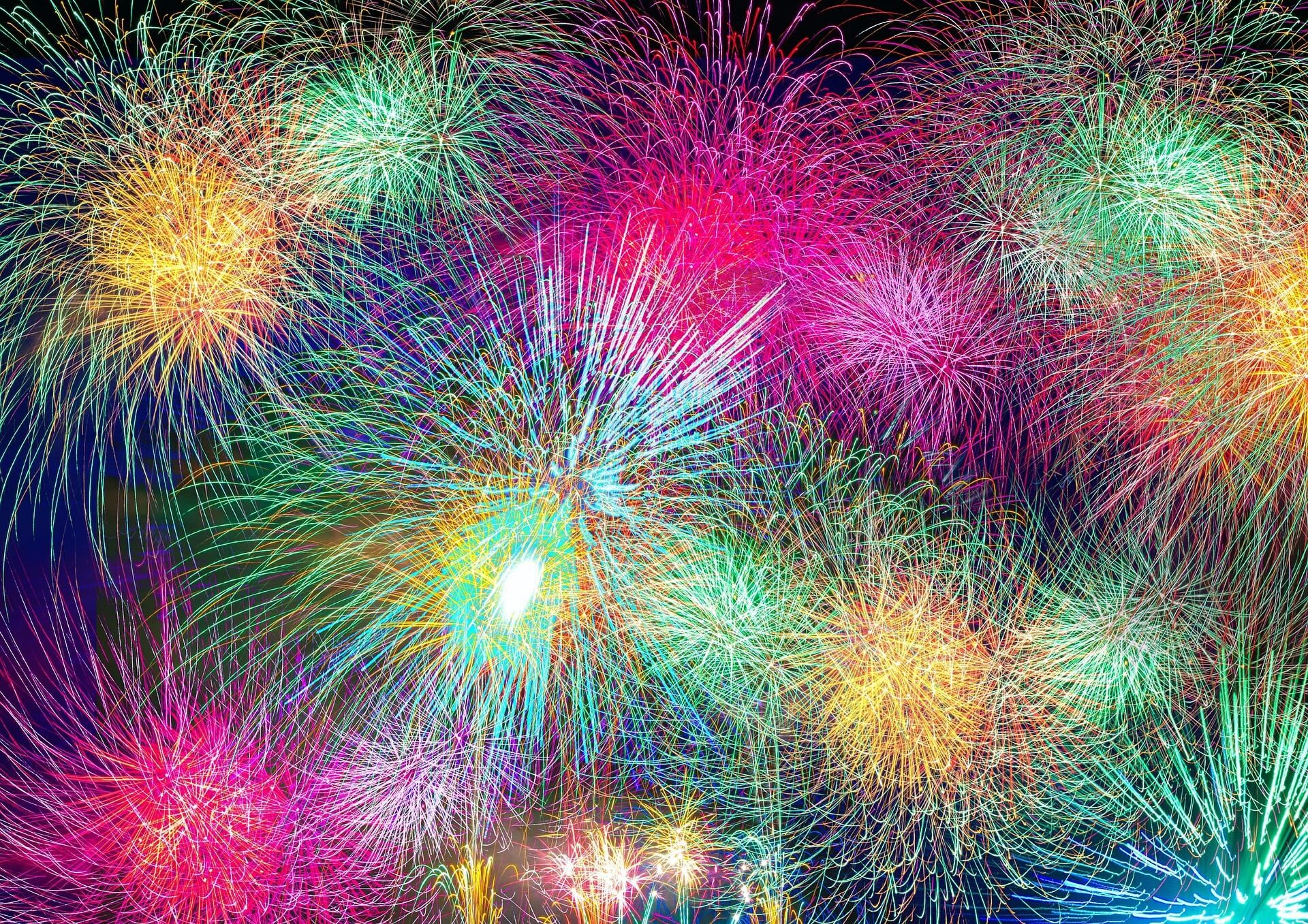 Vibrant fireworks exploding against a dark night sky, celebrating New Year's Eve