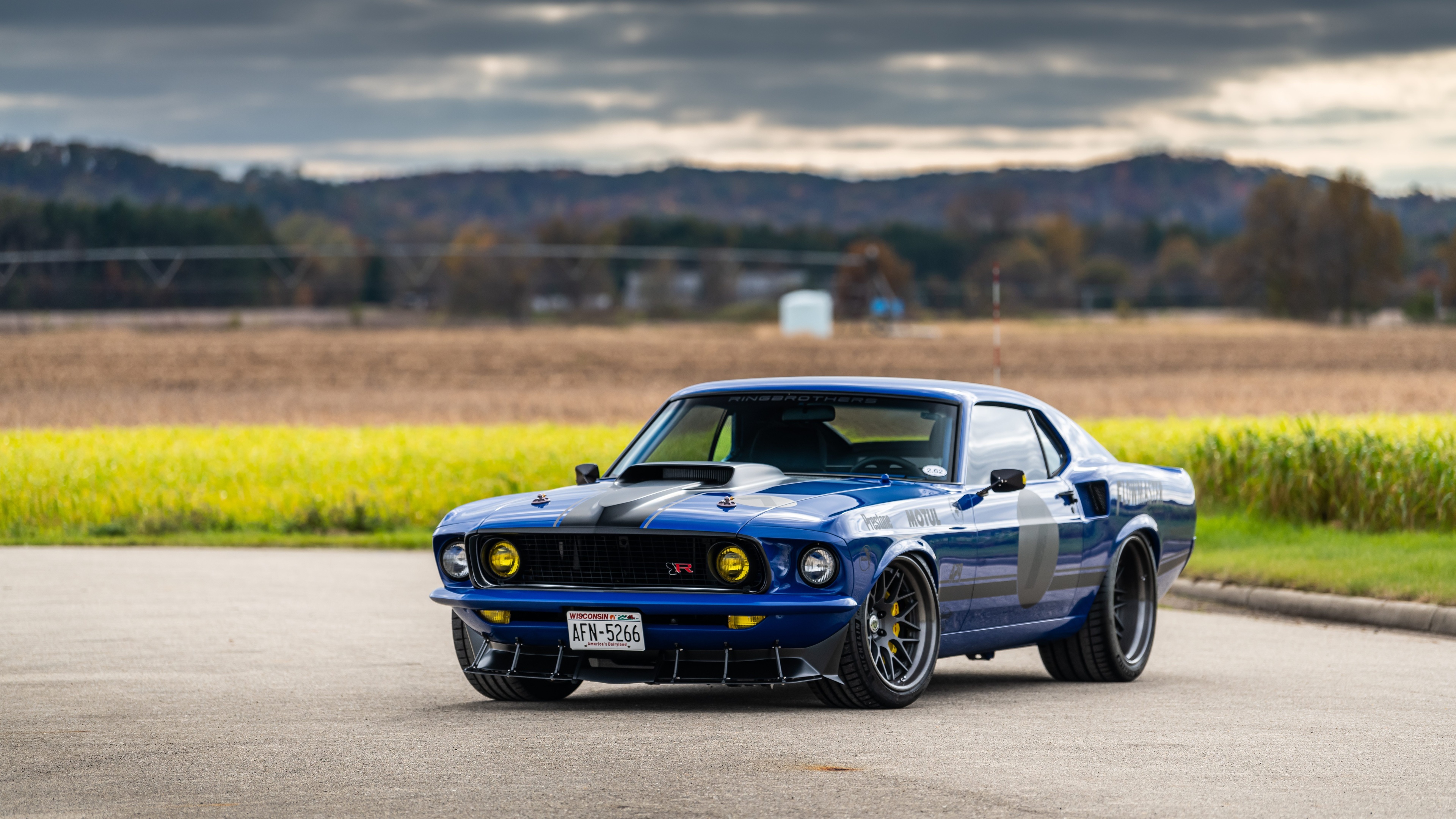 A Customized Blue Ford Mustang on a Country Road