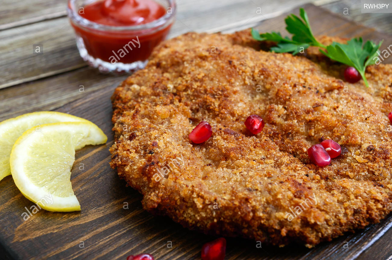 Free download Large Viennese schnitzel on a wooden background Meat dish