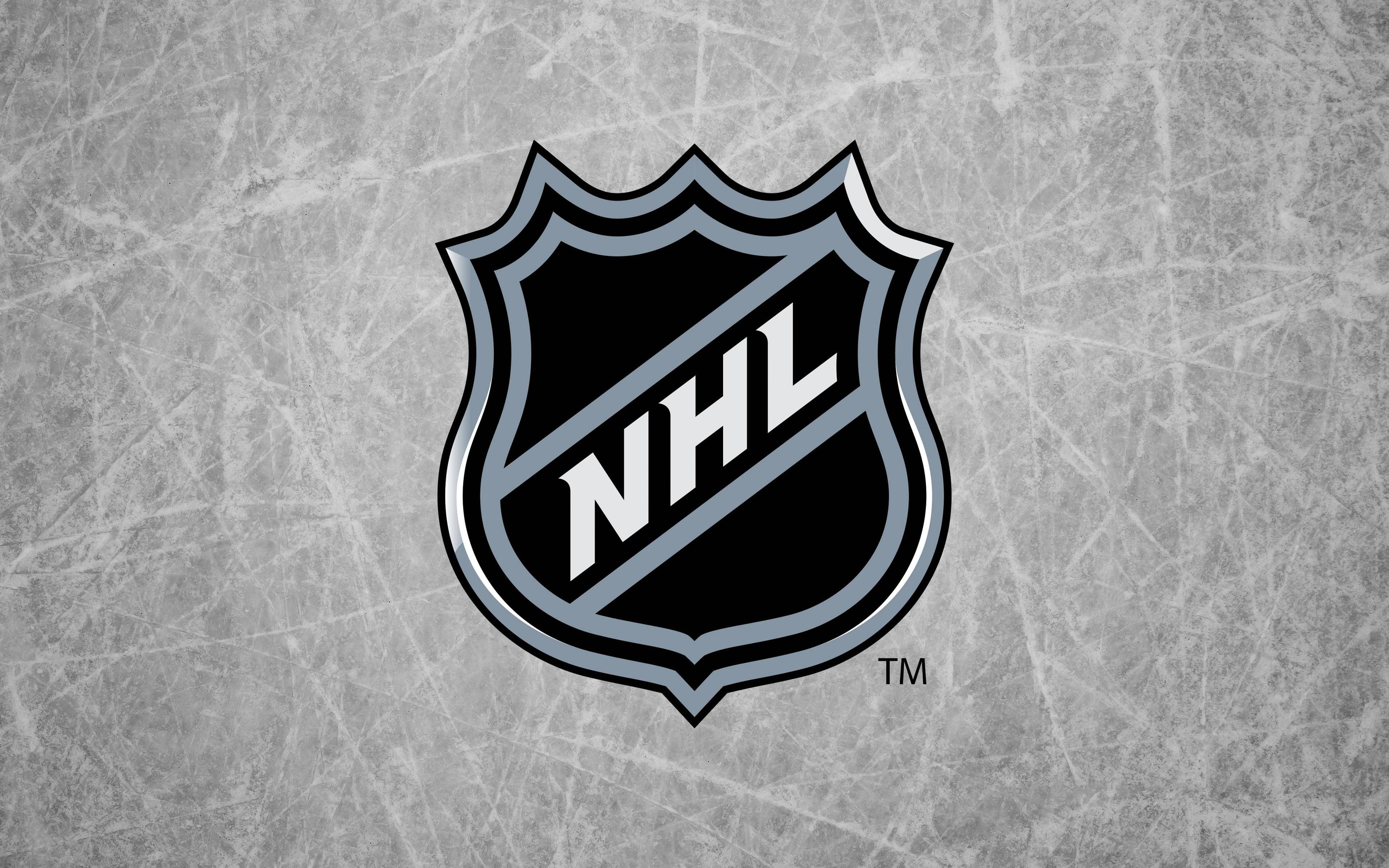 NHL Logo on Ice Background: A hockey wallpaper featuring the official National Hockey League (NHL) logo on a textured ice rink background