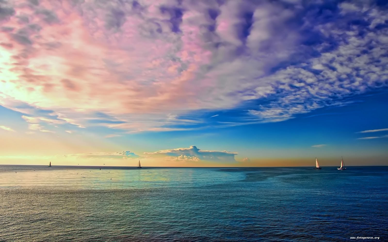Sailboats on Calm Blue Sea at Sunset