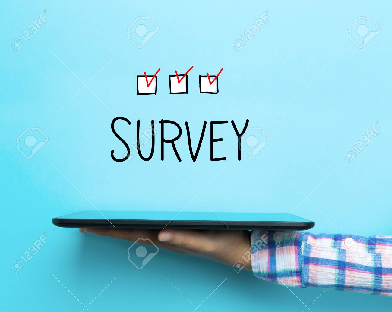 Survey Concept With A Tablet On Blue Background Stock Photo