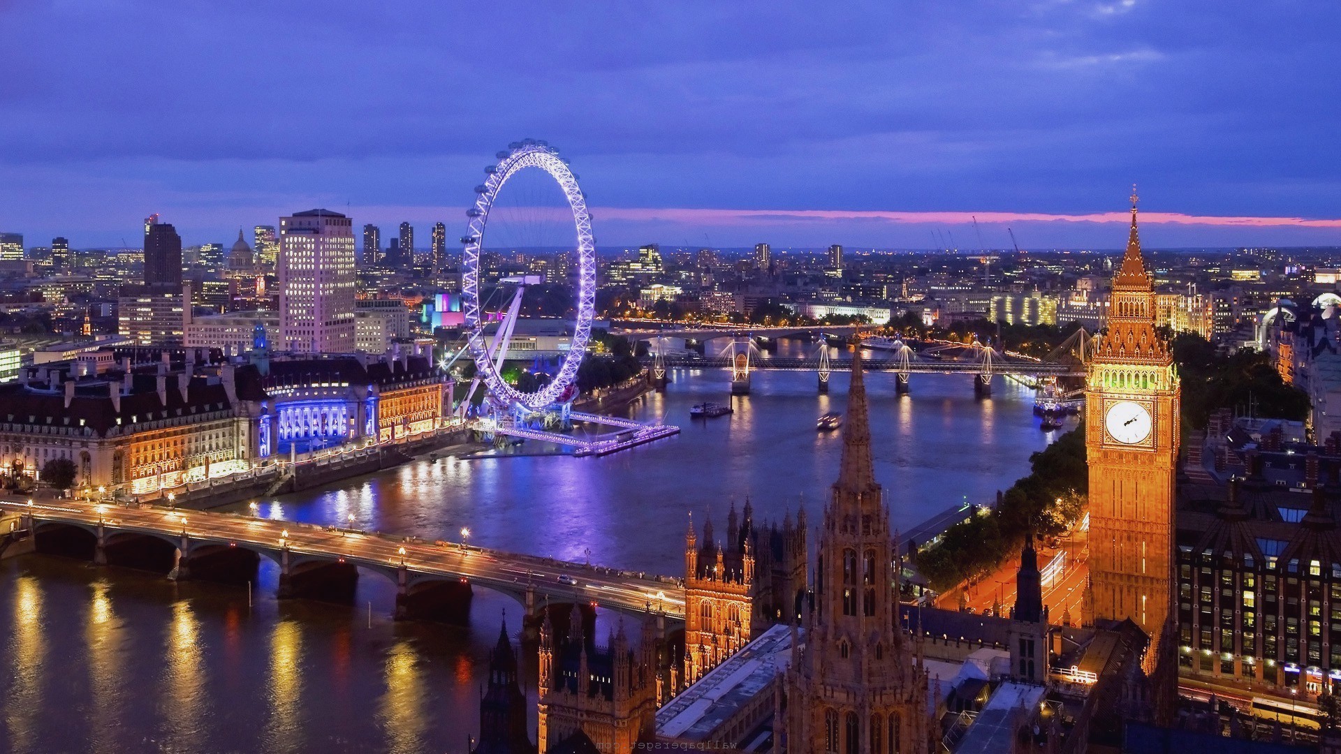 London skyline at night with the London Eye, Big Ben, and Westminster Palace illuminated