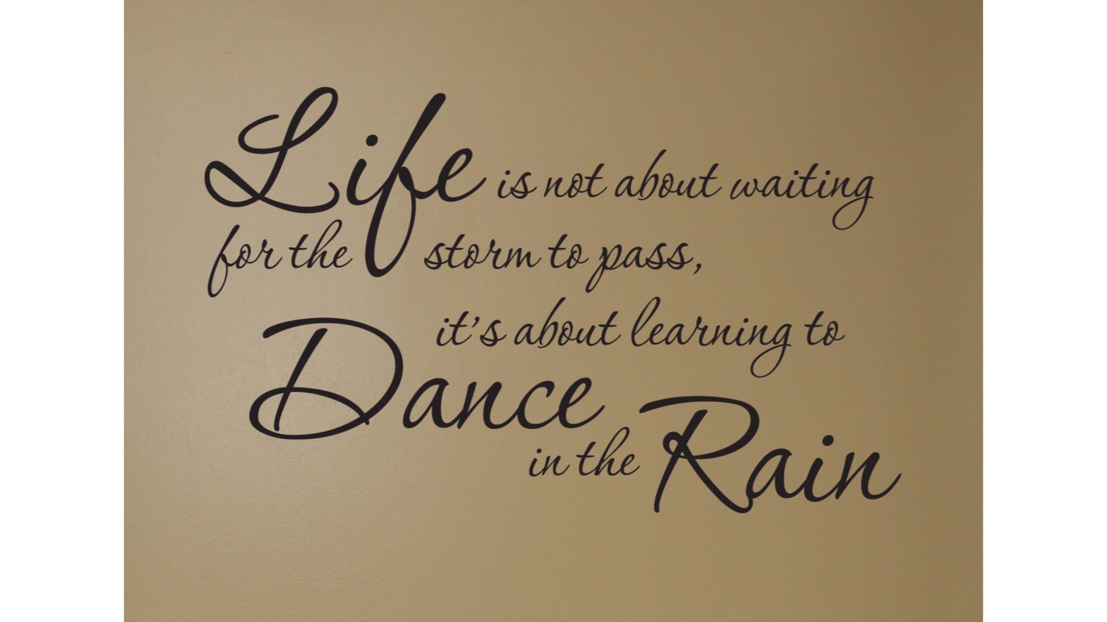 A stylish typography image featuring the inspirational quote 'Life is not about waiting for the storm to pass, it's about learning to dance in the rain.' Ideal for anyone seeking motivation and positivity