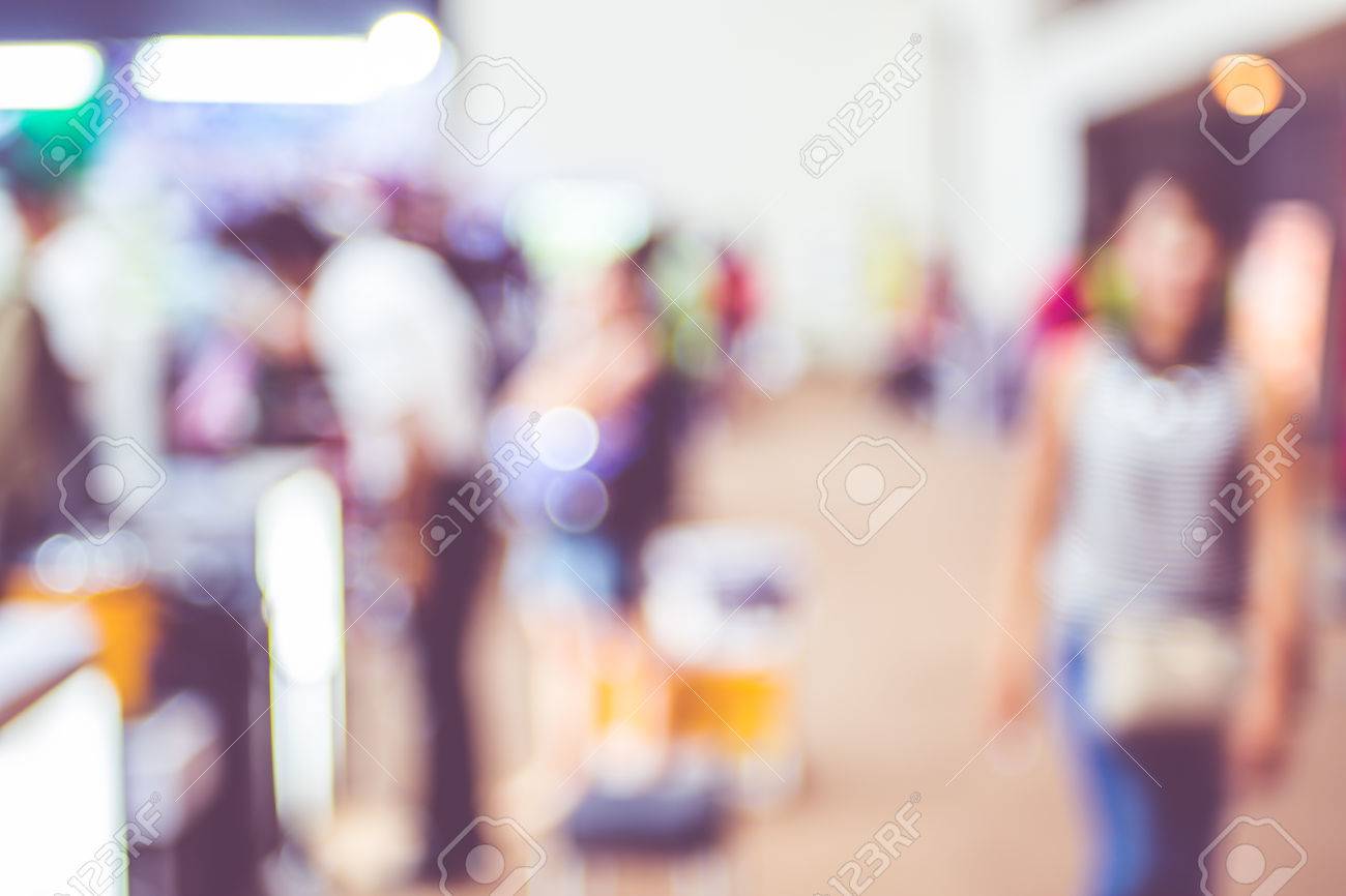Blurred Background Crowd Of People In Expo Fair With Bokeh Light