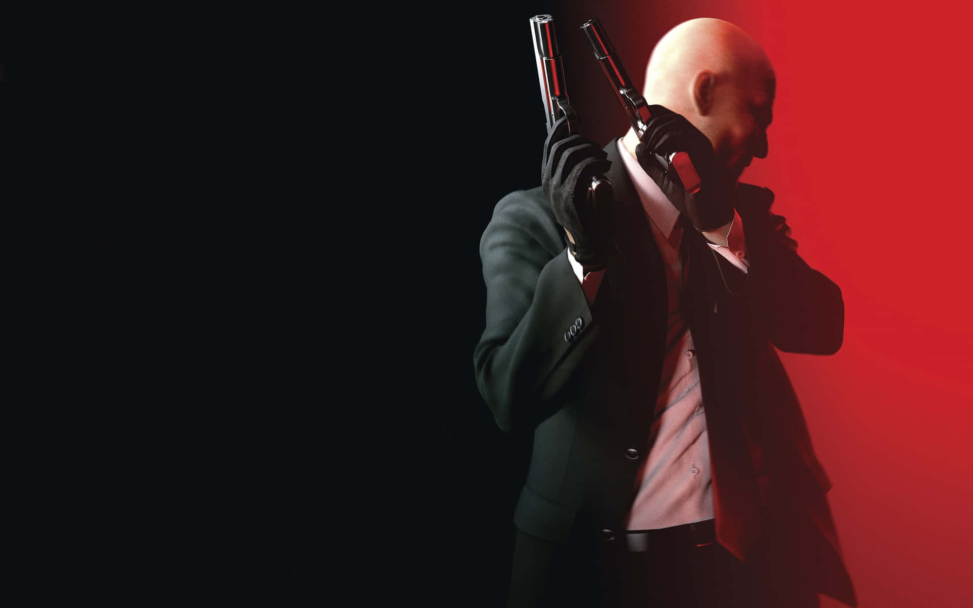 A man in a suit and gloves holds two handguns, resembling a promotional image for the Hitman video game series
