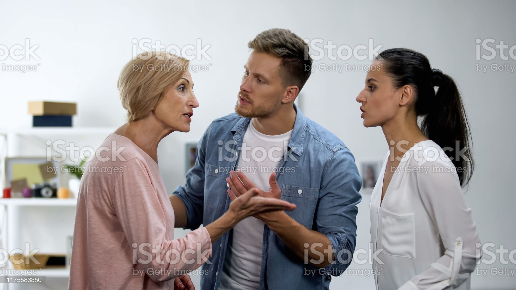 Young Man Settling Conflict Between Mother And Wife Family