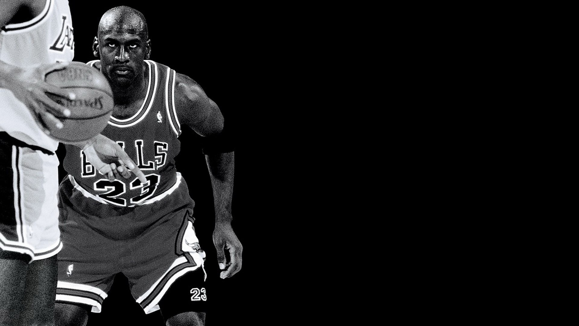 Michael Jordan dribbling a basketball in a black and white photo
