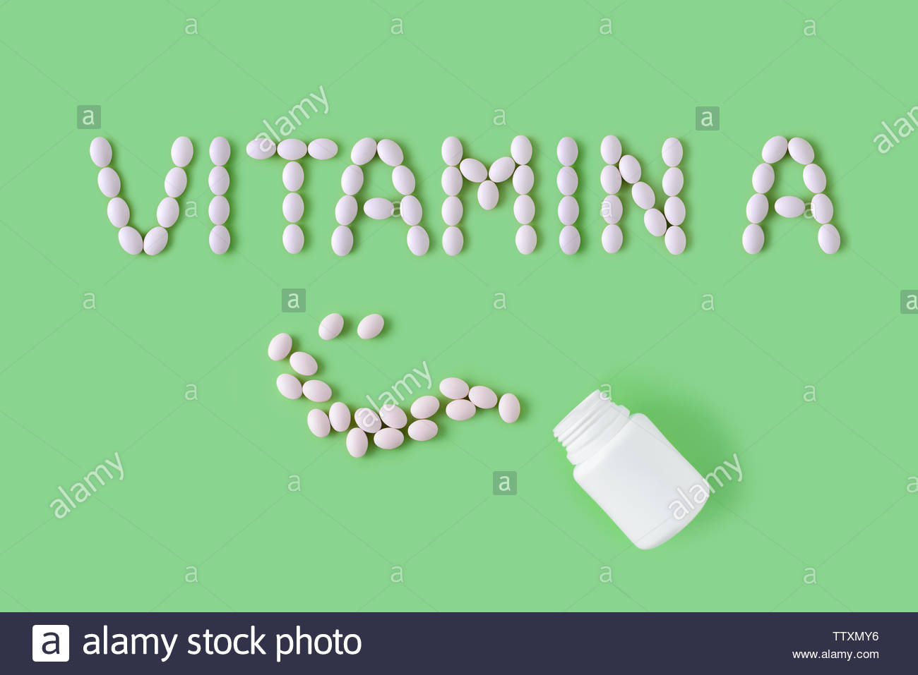 Pills Dropped In Shape Of Words Vitamin A From Bottle On Green