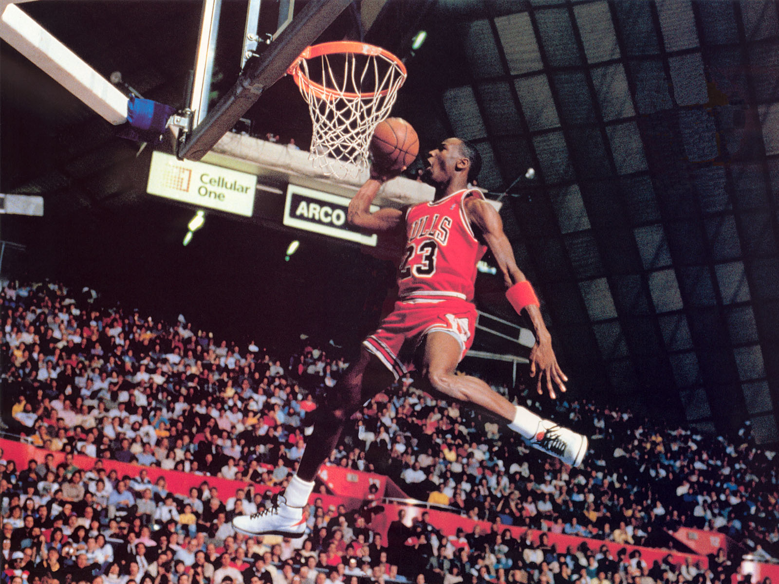 Michael Jordan performing a powerful dunk during a Chicago Bulls game