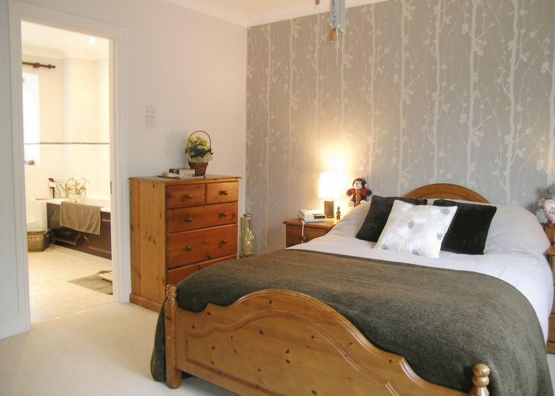 Photo Of Beige Grey Pine Bedroom With Feature Wall Wallpaper