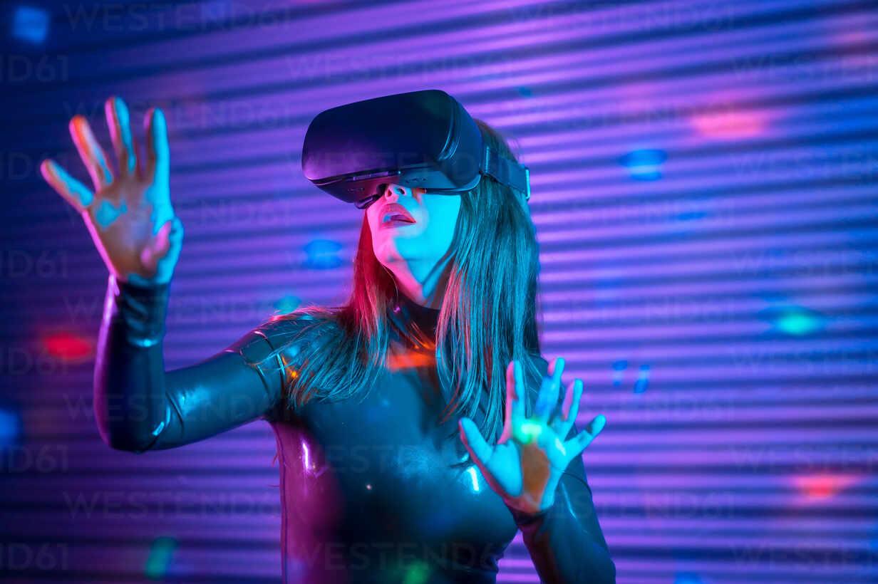 Young Woman In Vr Headset Gesticulating And Interacting With