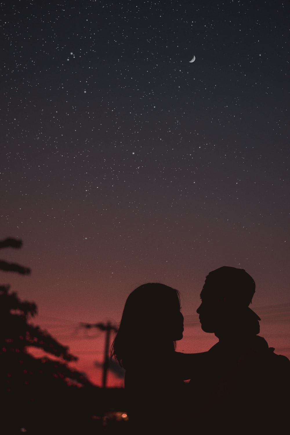 Silhouette Of Woman Hugging Mna Under Starry Night Sky Photo