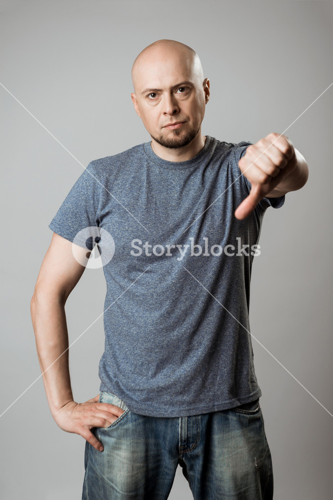 Displeased Young Man Showing Dislike Over Beige Background Royalty