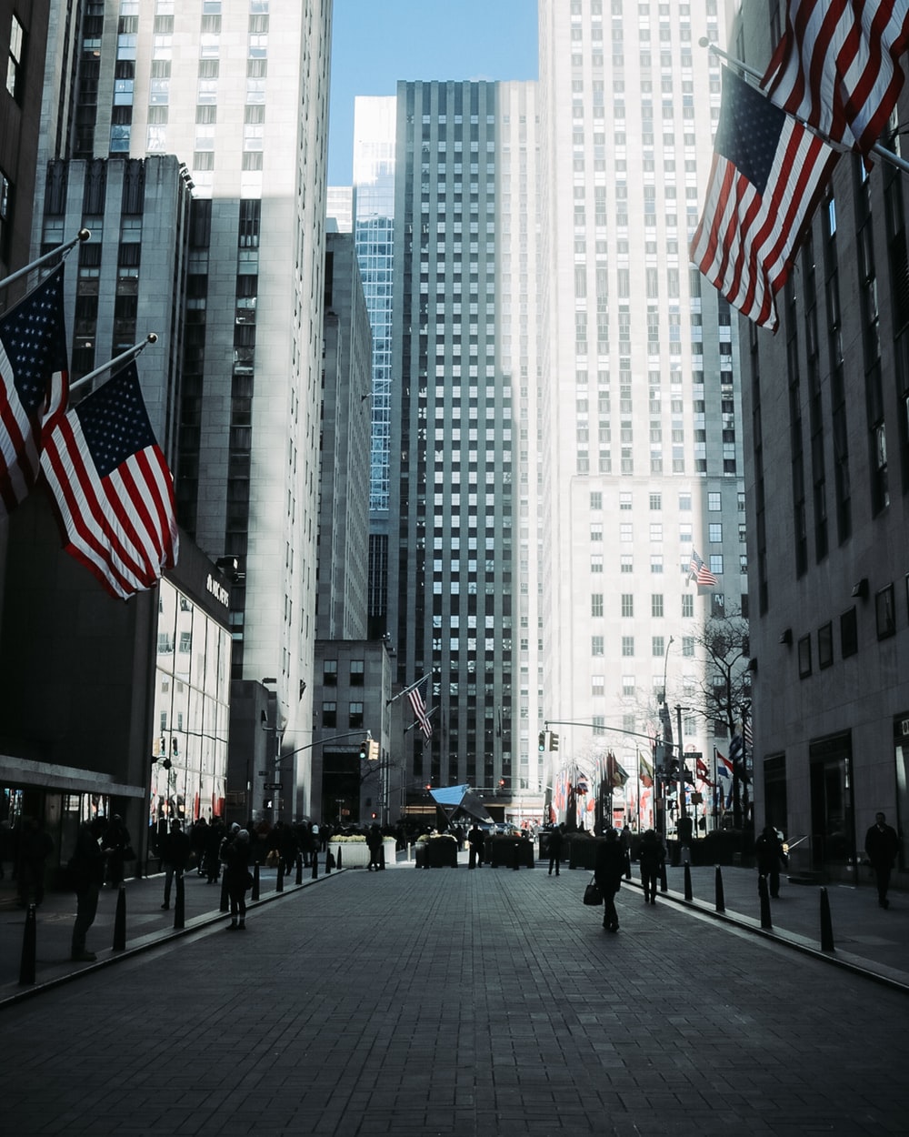 Four Us Flags Across White Tall Building Photo Rockefeller