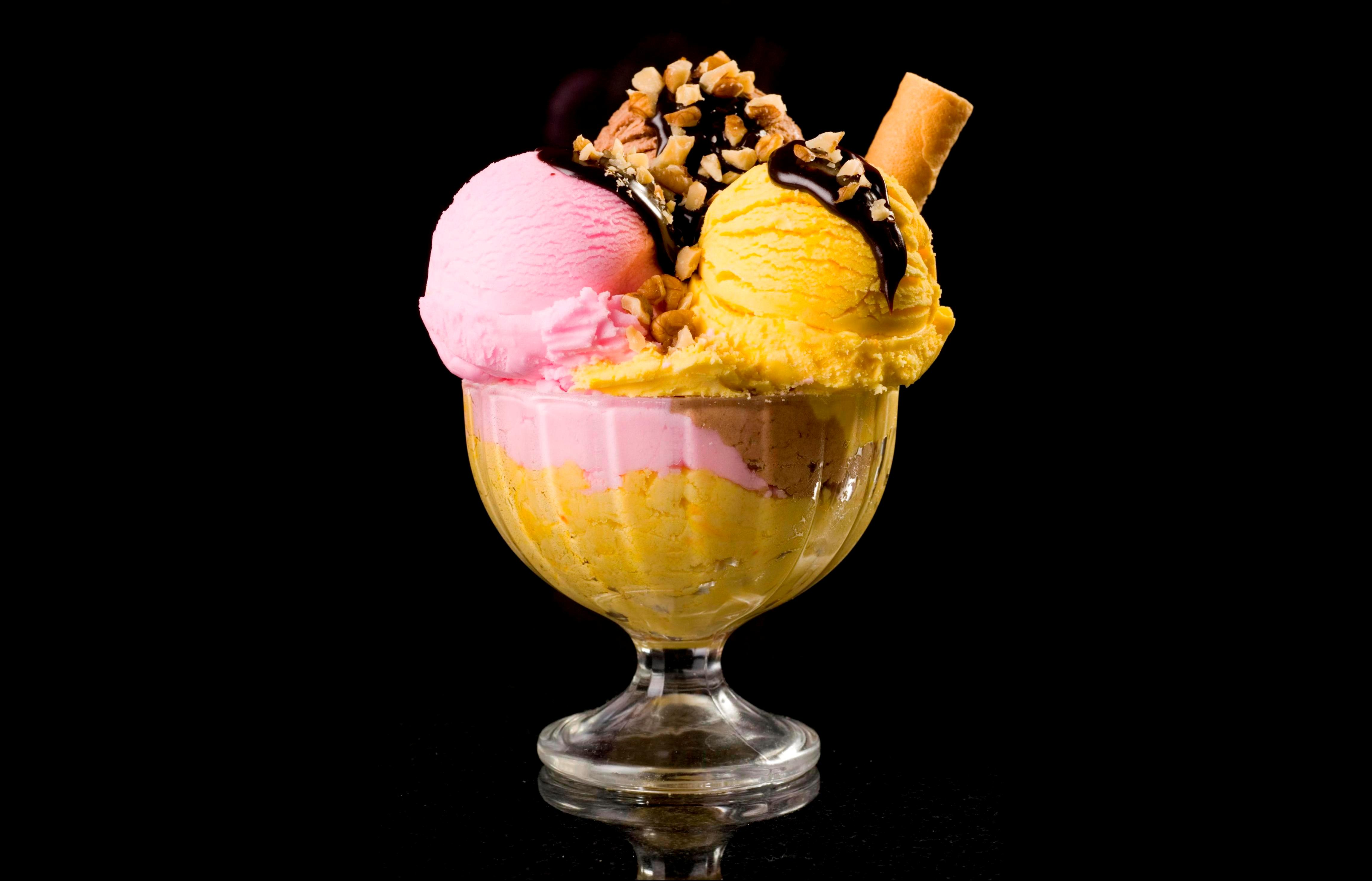 Balls Of Fruit Ice Cream In A Bowl With Nuts And Chocolate On