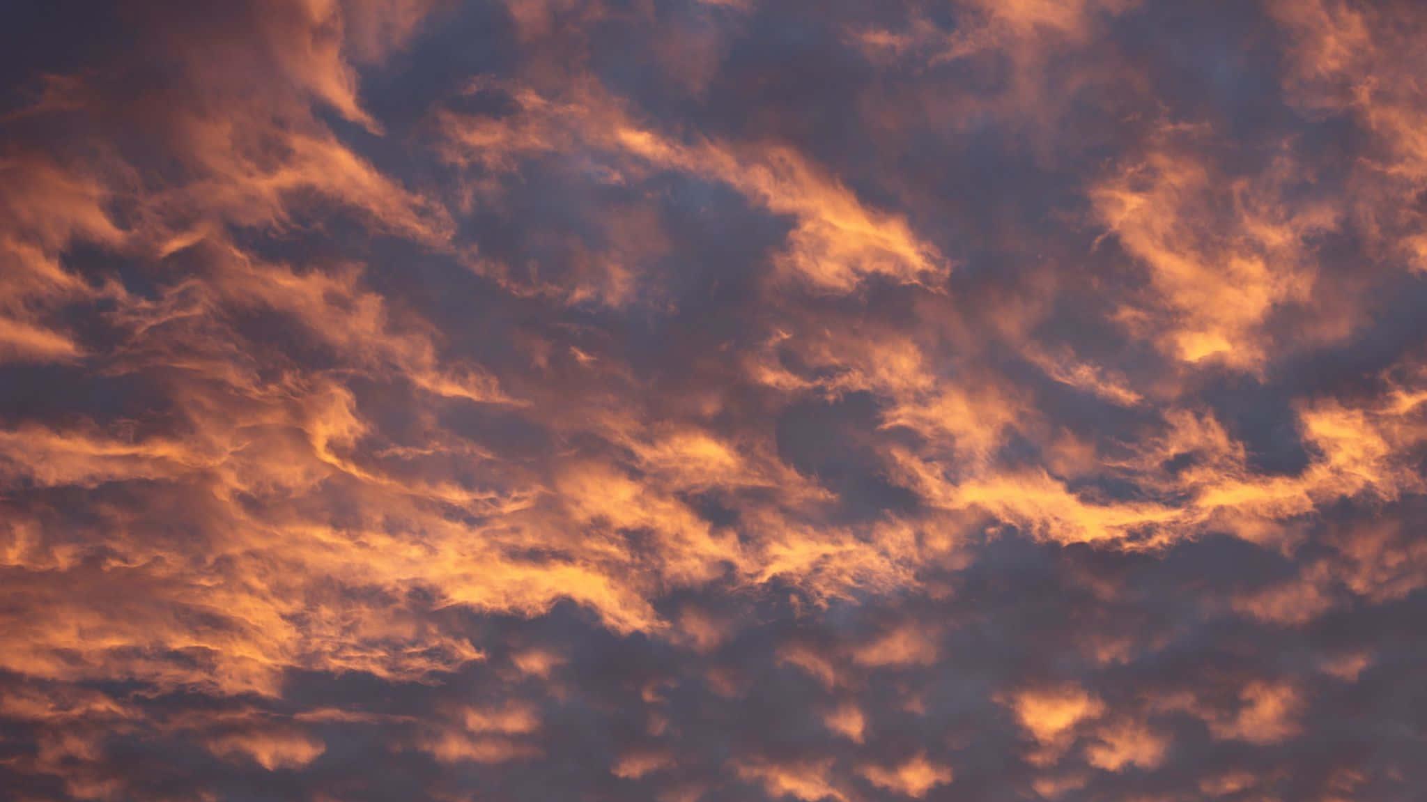 A Sunset With Clouds In The Sky Wallpaper