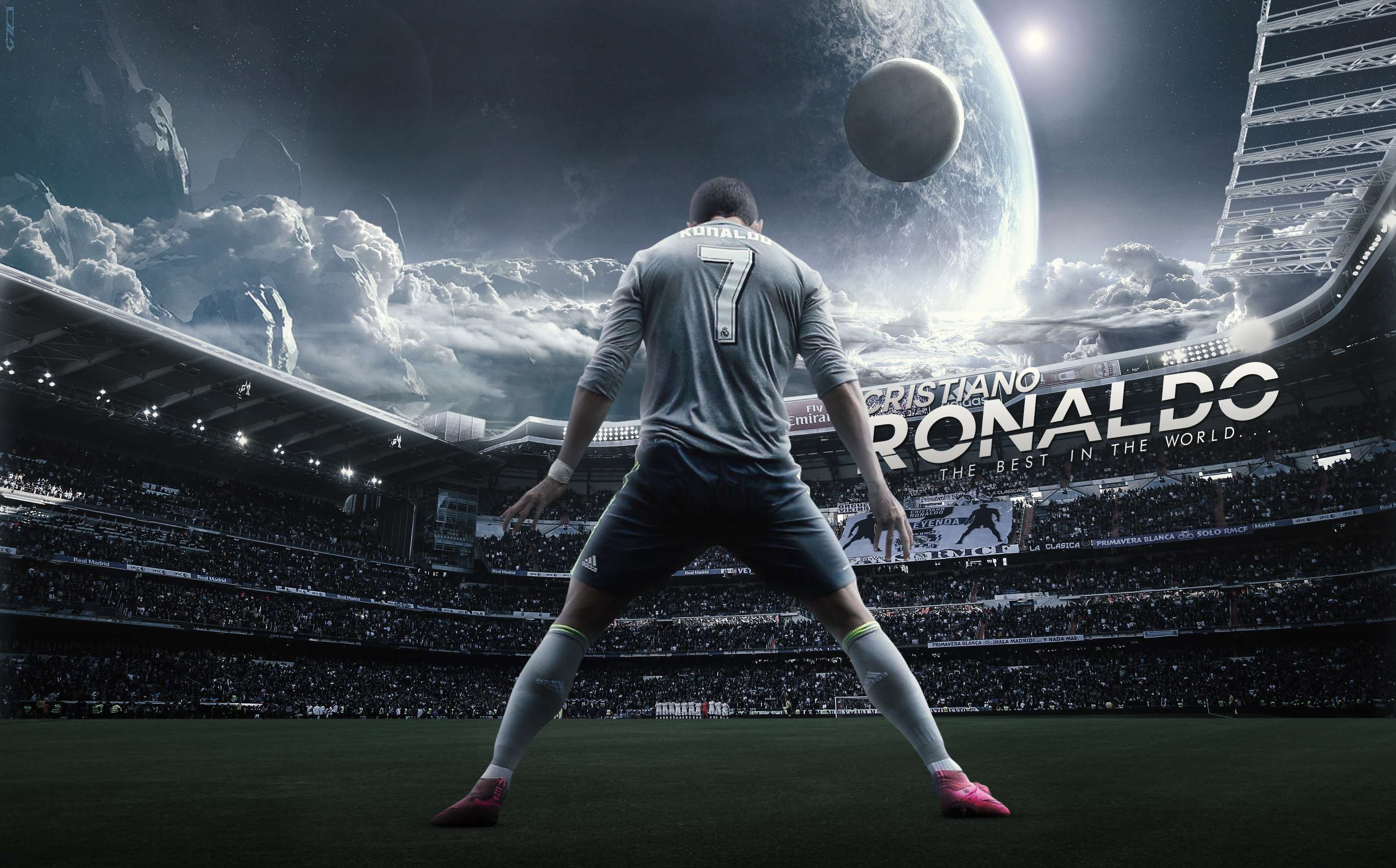 Cristiano Ronaldo standing on a soccer field with his back to the camera, legs spread wide, in a powerful stance. The backdrop features a dramatic sky with a large, ethereal planet and a packed stadium