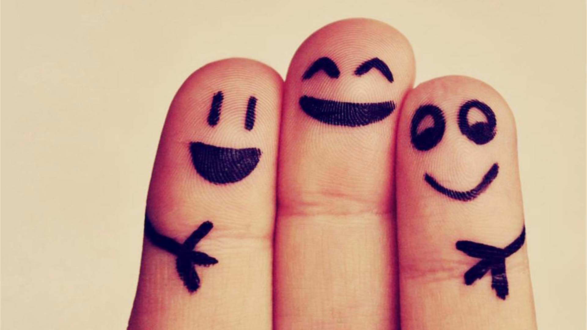 Four fingers with drawn faces and arms, symbolizing friendship and togetherness