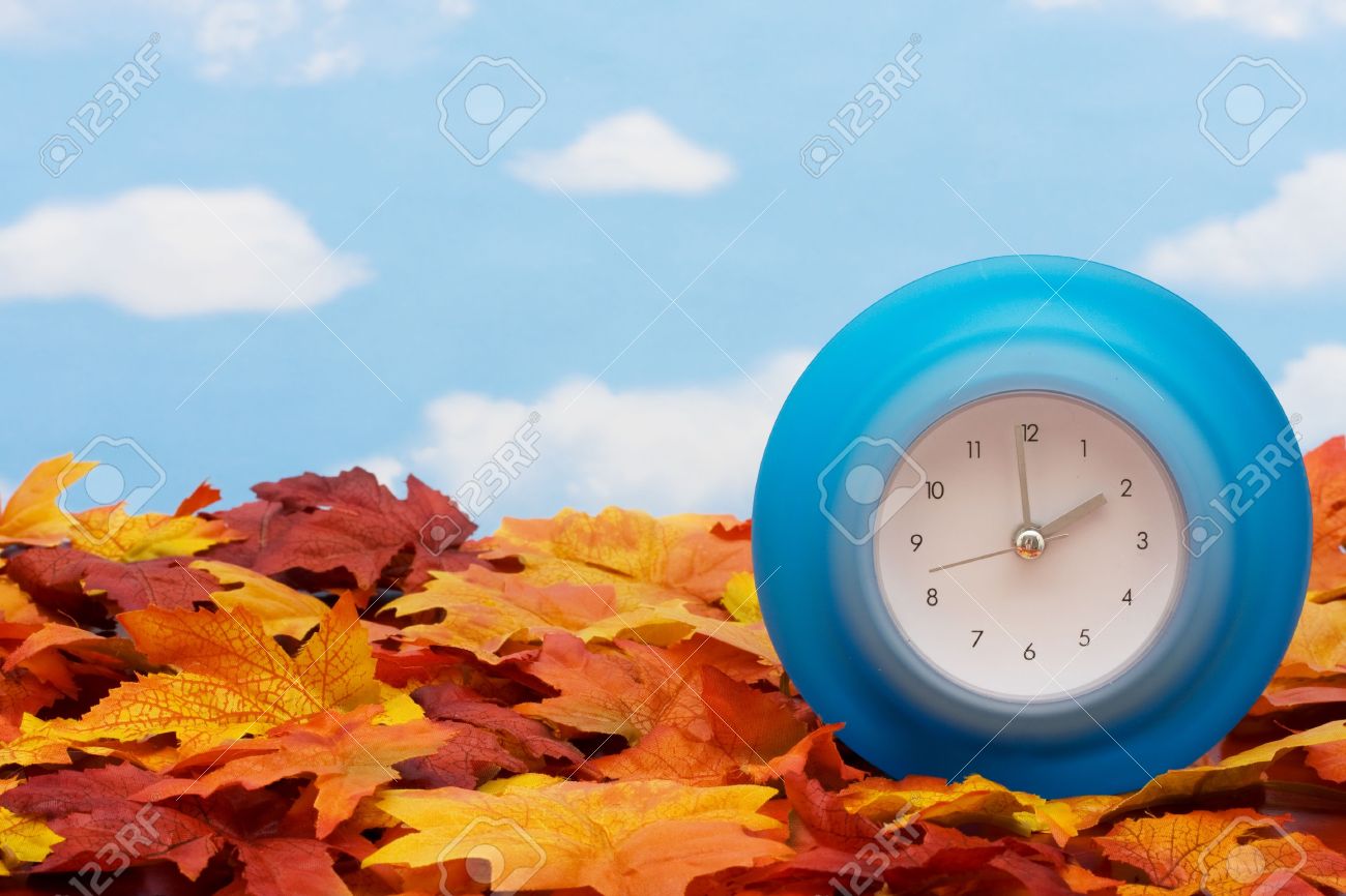 Fall Leaves With Blue Clock On Sky Background Back Time