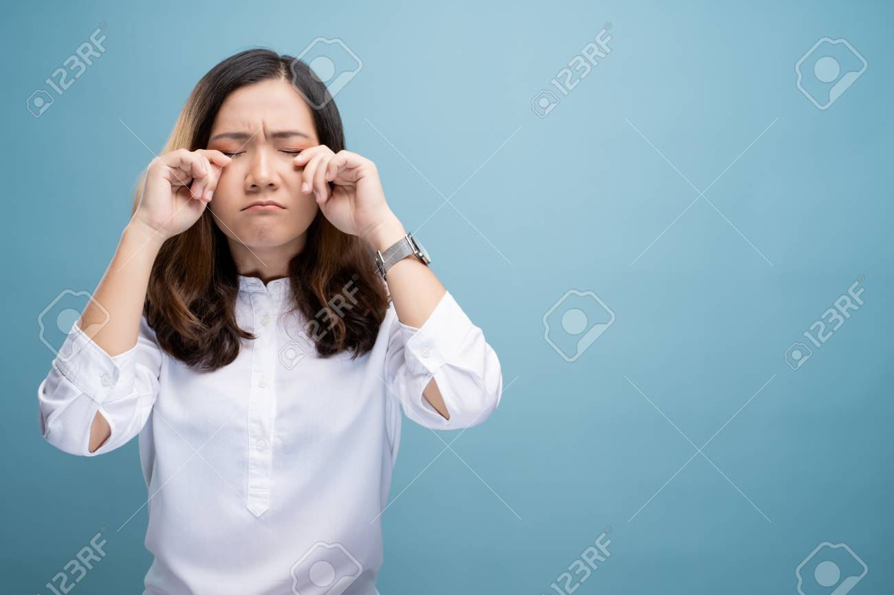 Sad Woman Crying And Standing Isolated On Blue Background Stock