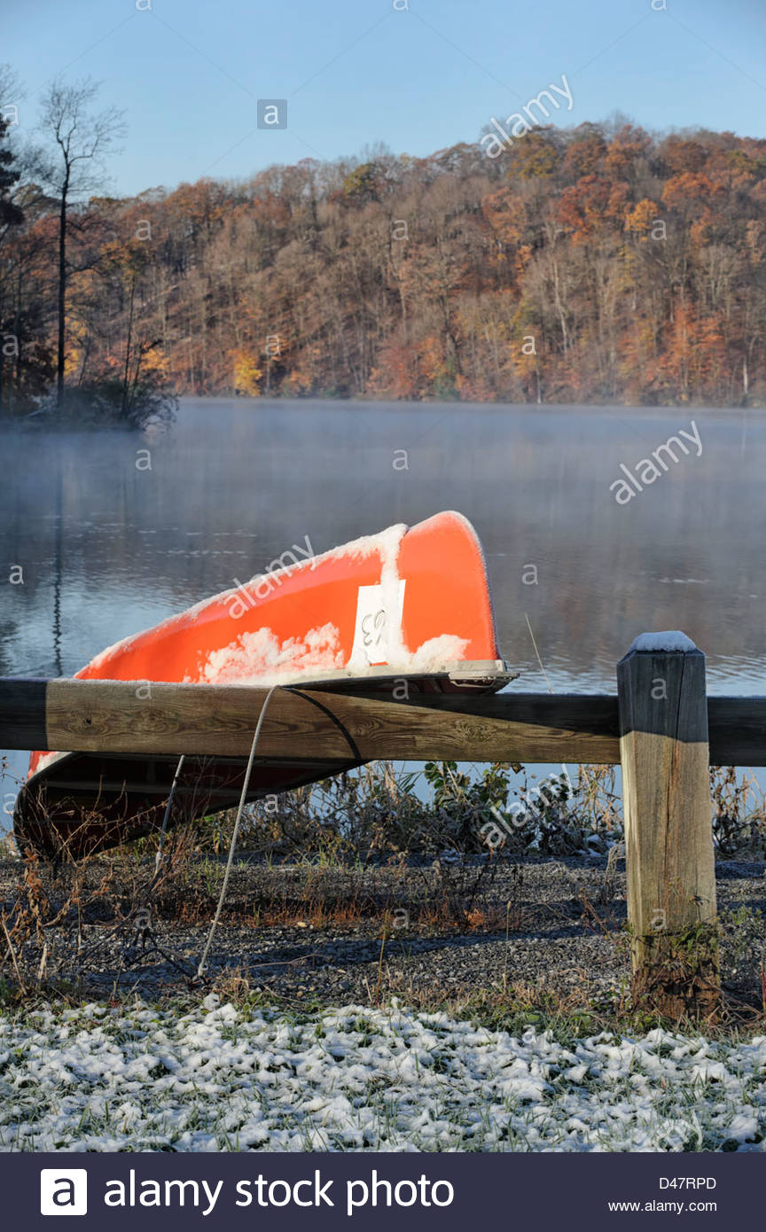 Canoe At A Snowy Foggy Lake In Cold Morning Sunshine Fall