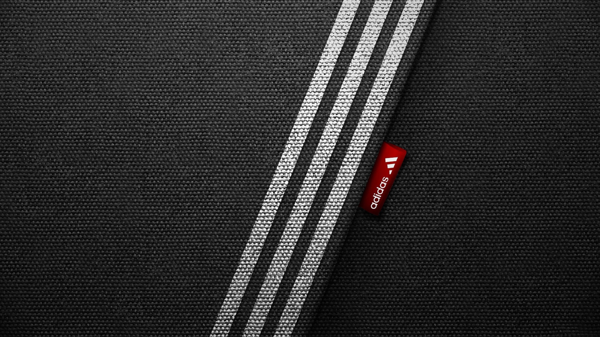 Close-up of Adidas fabric with signature three stripes and logo