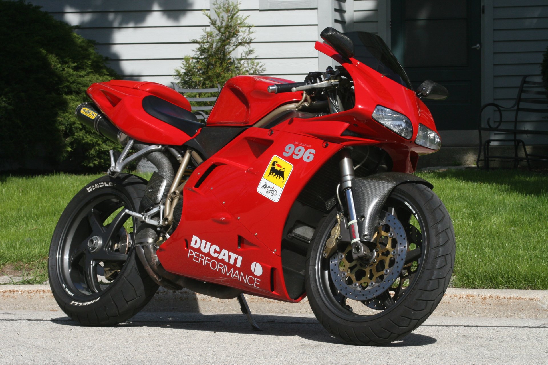 Red Ducati 996 parked on a residential street