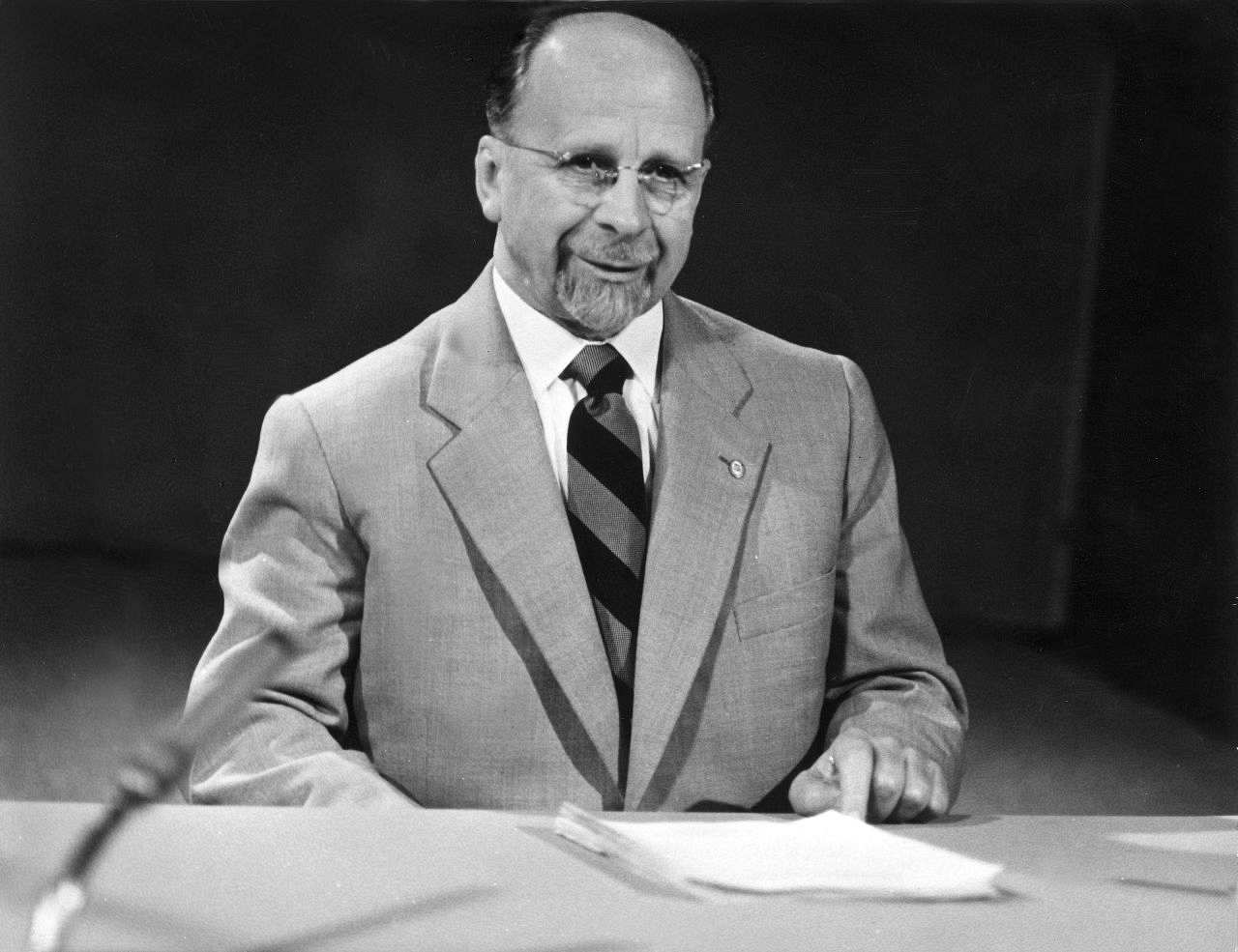 A black and white portrait of a man in a suit and tie