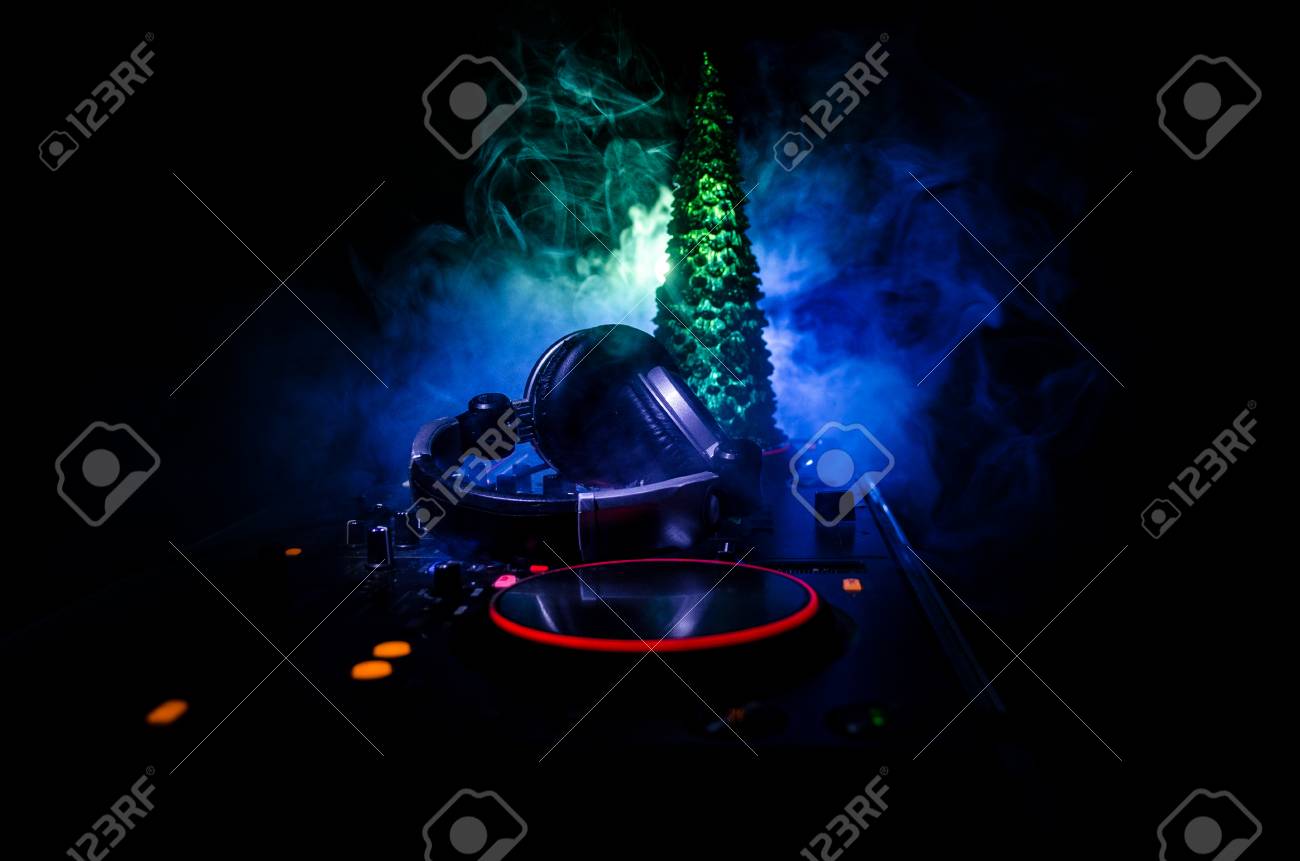 Dj Mixer With Headphones On Dark Nightclub Background
