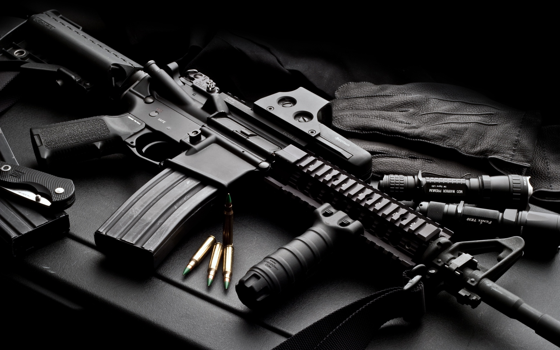 A high-powered tactical rifle, complete with accessories like a scope, flashlight, and grip, displayed against a dark backdrop