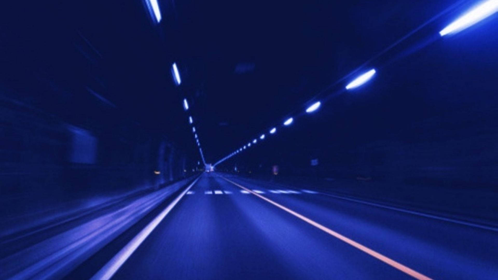 A vibrant neon blue tunnel with streaks of light, giving a sense of speed and movement