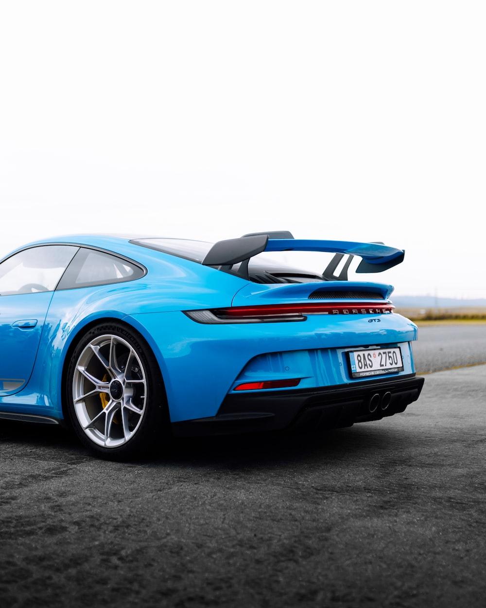 Blue Porsche On Road Photo Image