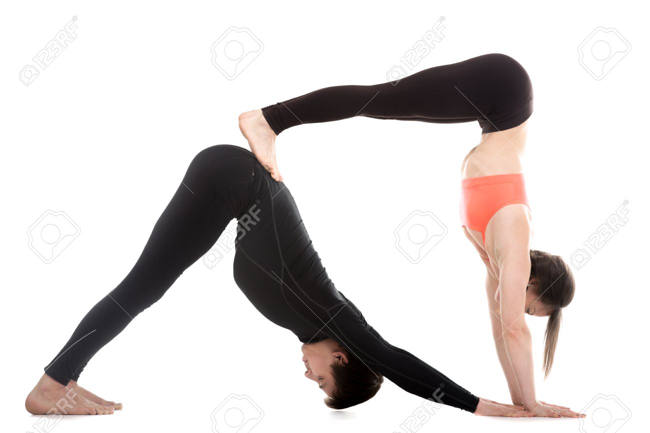 Two Sporty People On White Background Doing Acroyoga Yoga With
