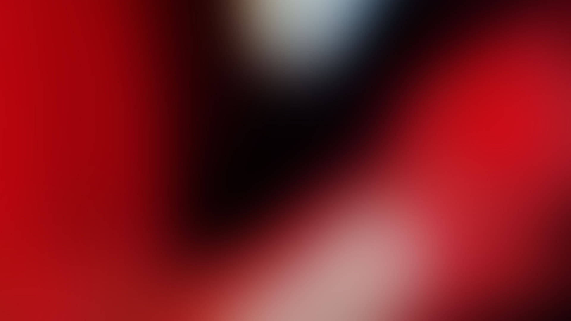 A blurred, abstract background with shades of deep red, black, and a subtle hint of light gray