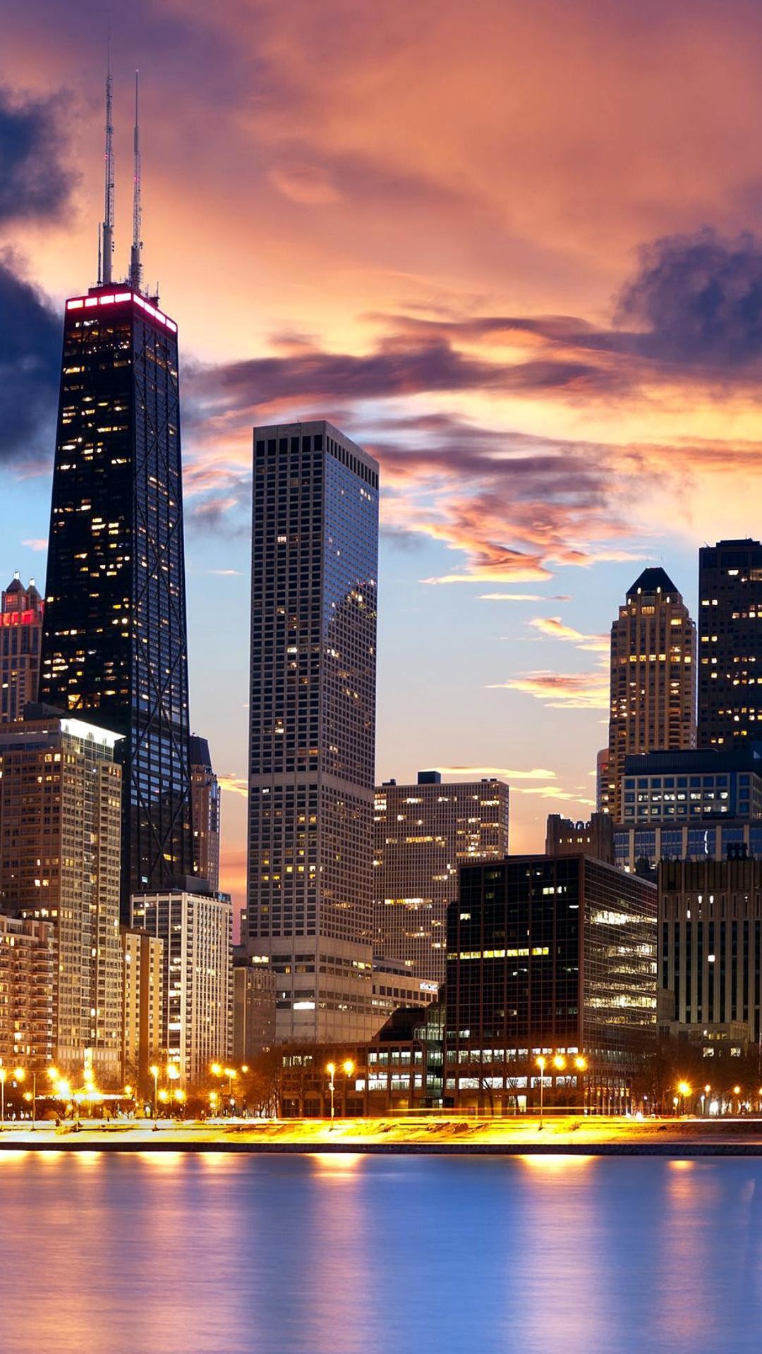 Chicago skyline at sunset with skyscrapers reflecting in Lake Michigan