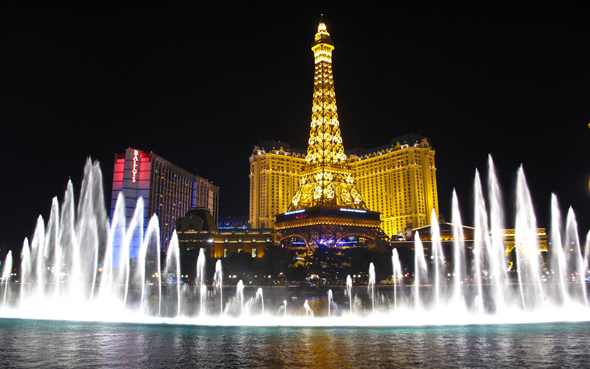 Bellagio Fountains And Hotel Paris With Eiffel Tower Las