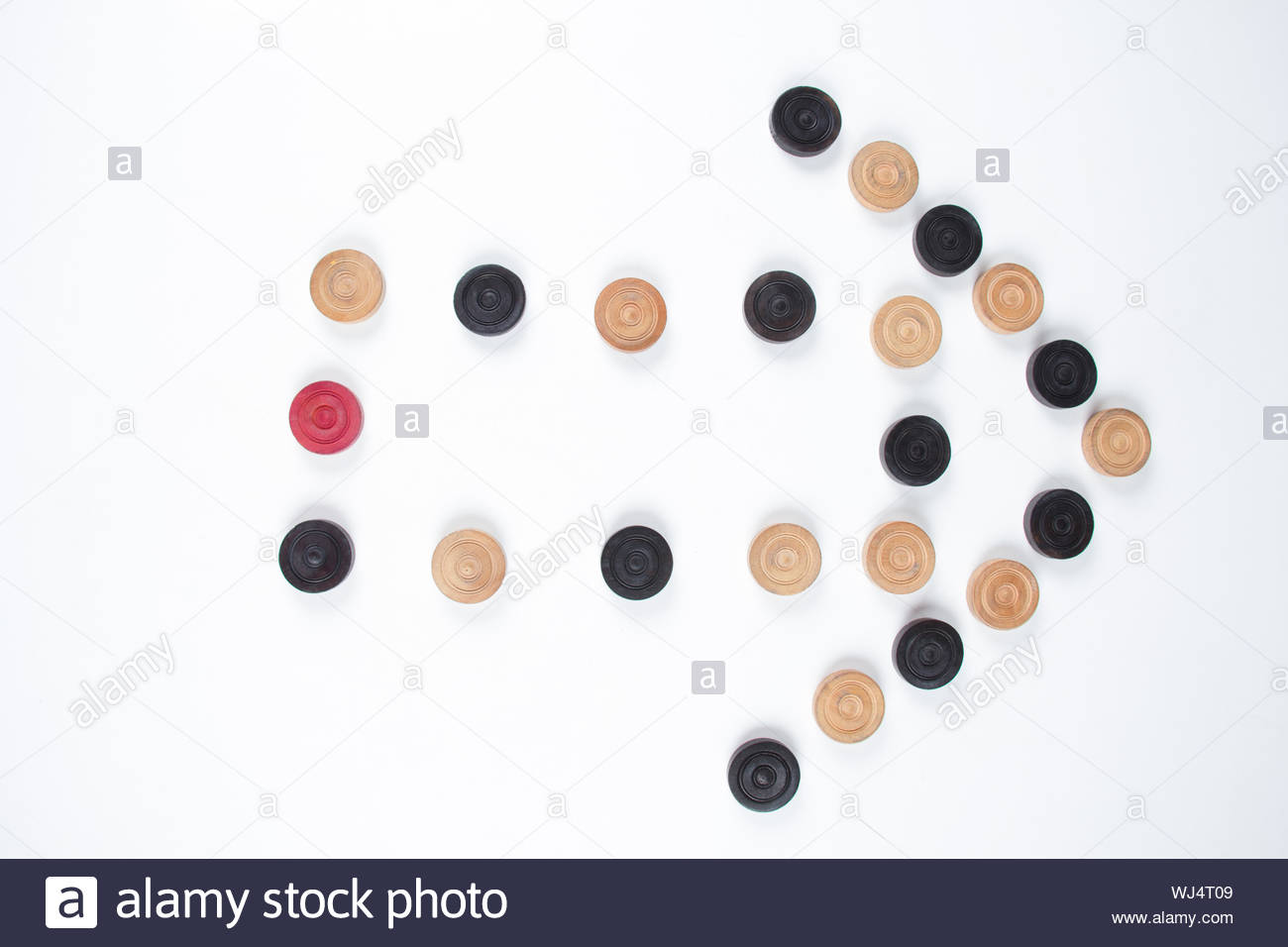 Carrom Pieces In Shape Of Arrow Sign Isolated On White Background