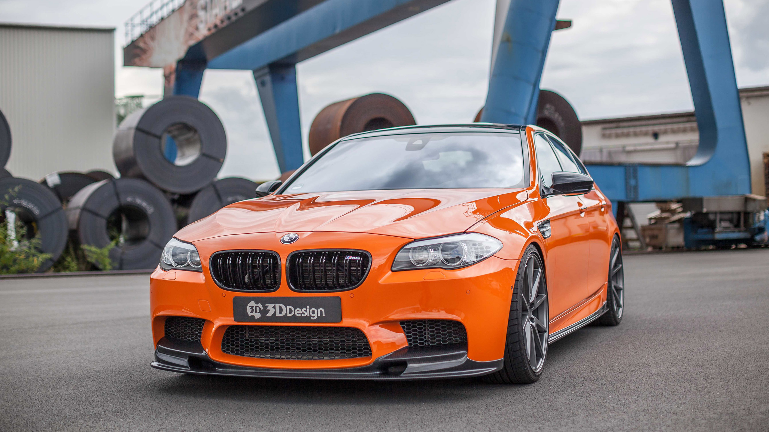 Bright Orange Tuned BMW M5 in Industrial Setting