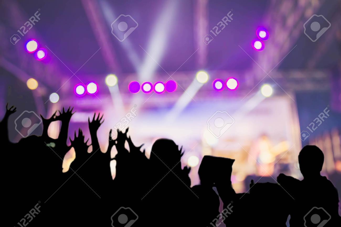 Silhouette Audience On Blurred Concert Stage Background Stock