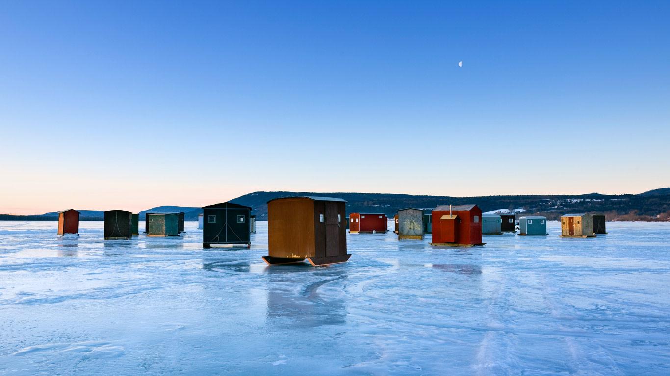 Ice Fishing Huts On Frozen Lake In New