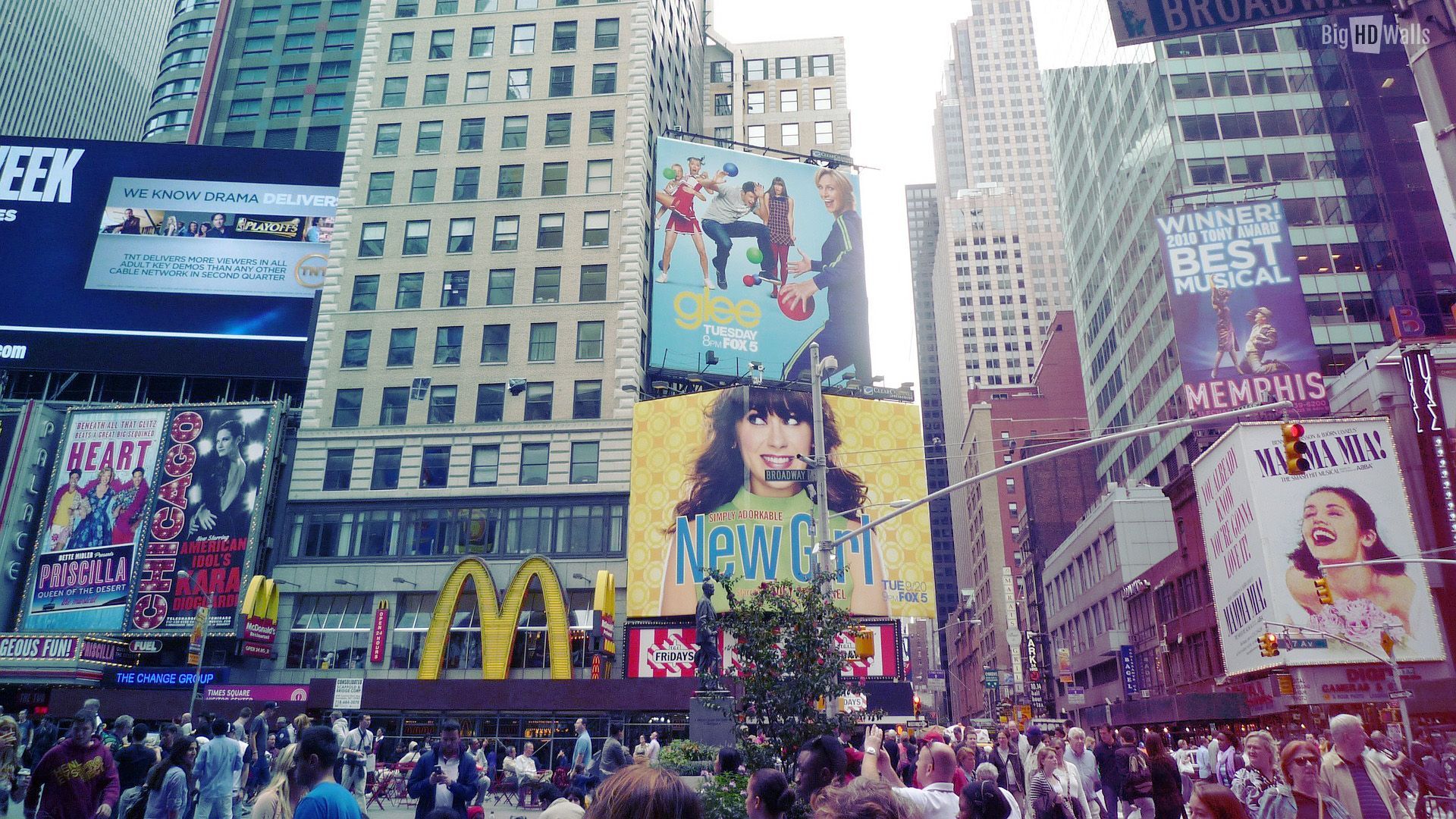 A bustling Times Square scene in New York City, featuring Broadway show advertisements for 