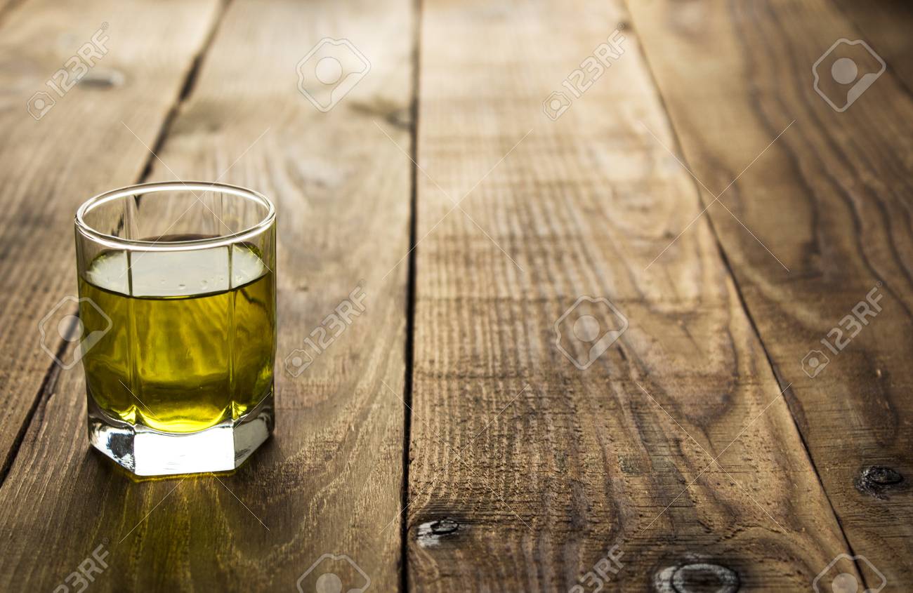 Yellow Alcohol Shot Drink On Wooden Background Stock Photo