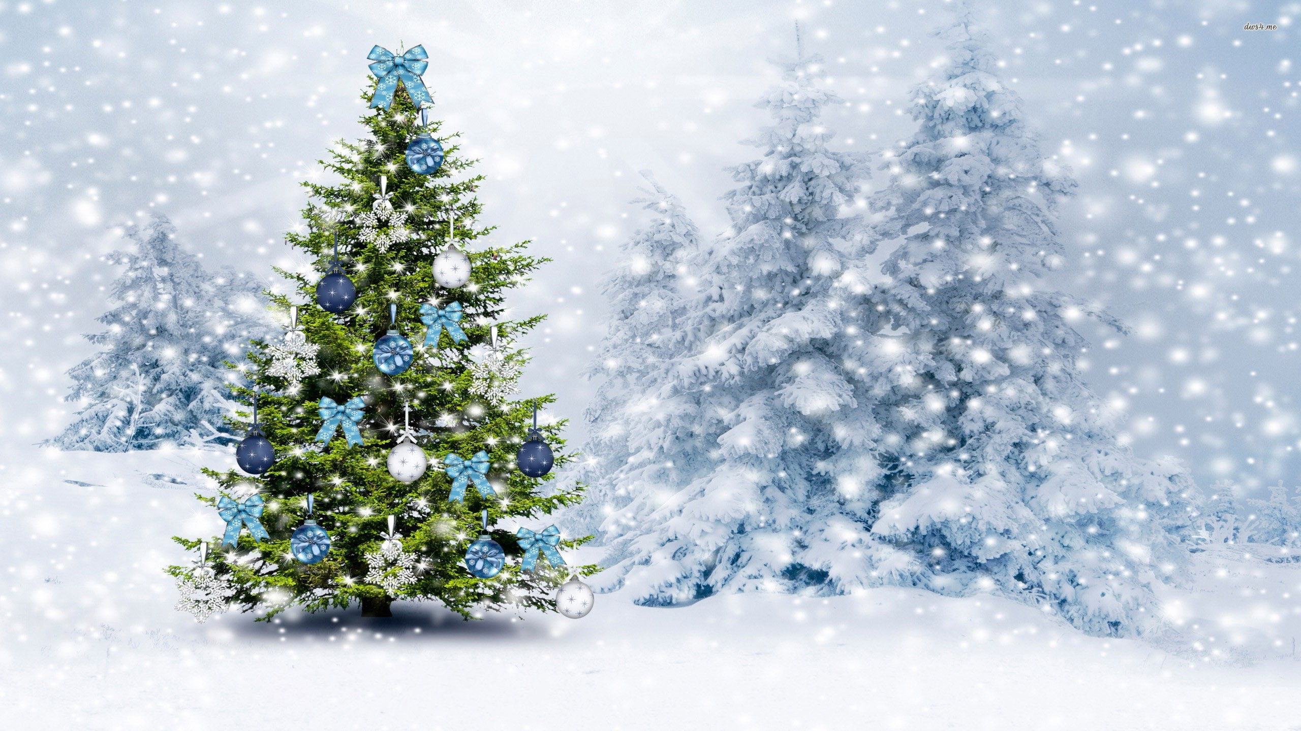 A decorated Christmas tree stands in a snowy forest, adorned with blue and silver ornaments and bows. Snow falls gently, creating a festive winter scene