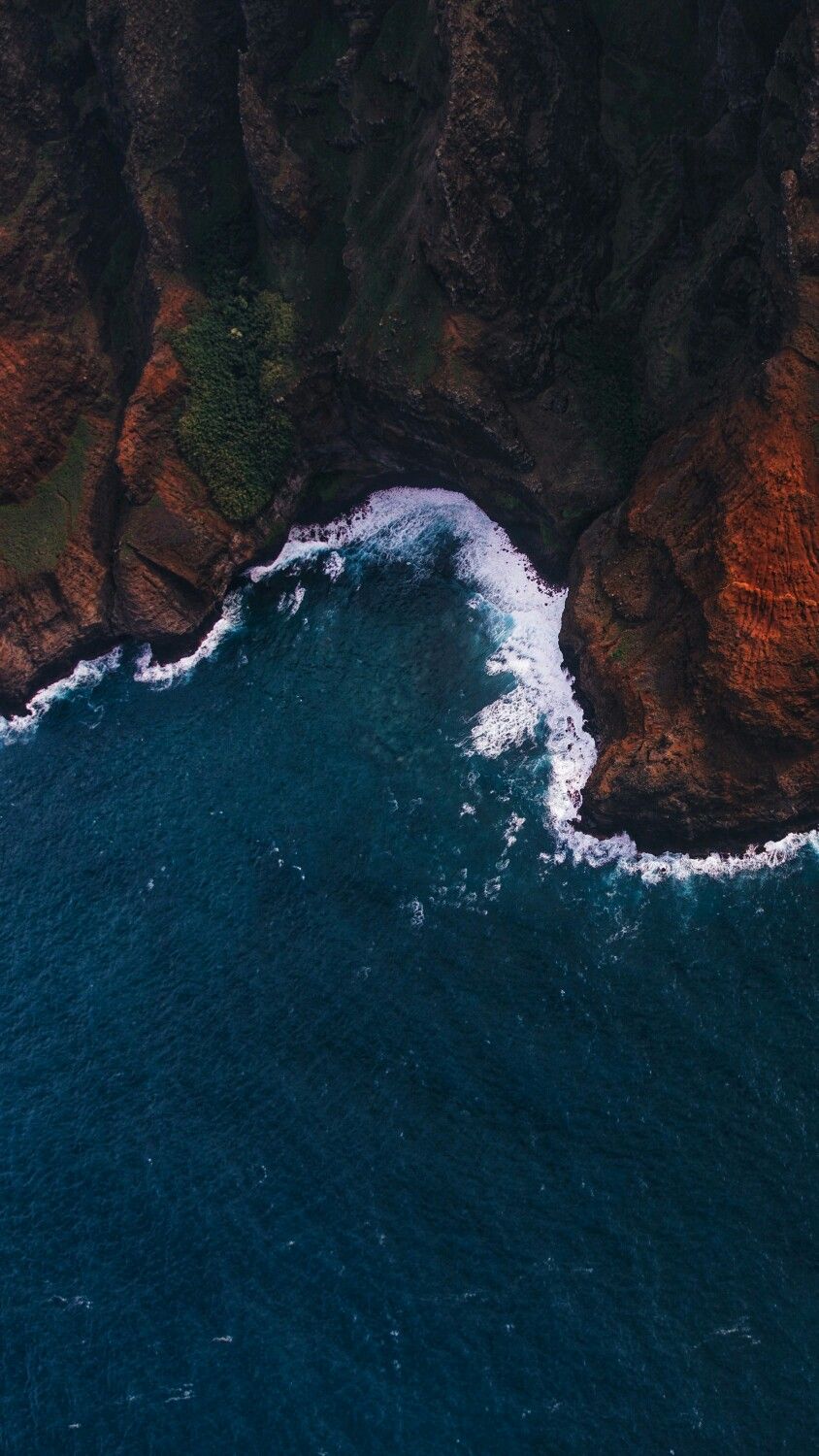 Crashing waves on a rough dark cliff edge Photography
