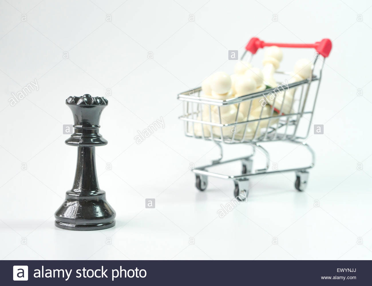 Black Queen With White Pawn Inside Toy Trolley Background Stock